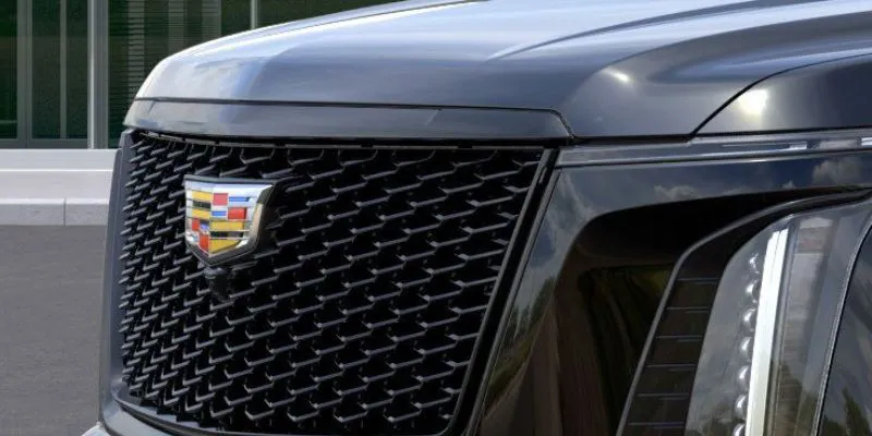 Close up of the modern black mesh grille and Cadillac emblem on a luxury executive SUV