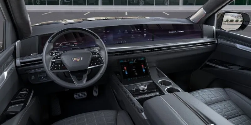 Luxury Cadillac Escalade interior featuring curved OLED dashboard screens, steering wheel, and leather seating