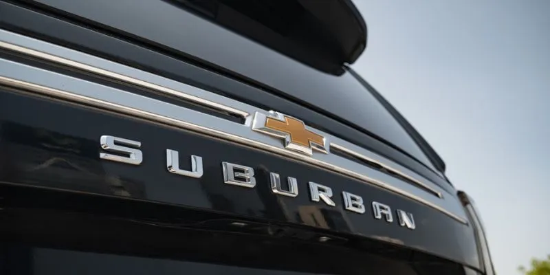 Close up view of the chrome Chevrolet Suburban rear badge and emblem on a black luxury SUV