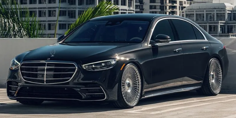Black Mercedes-Benz S-Class luxury sedan parked in urban location for private chauffeur transportation
