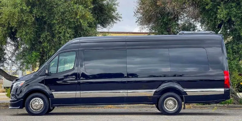 Full side profile of a black Mercedes Sprinter high-roof van for private shuttle and event charter service