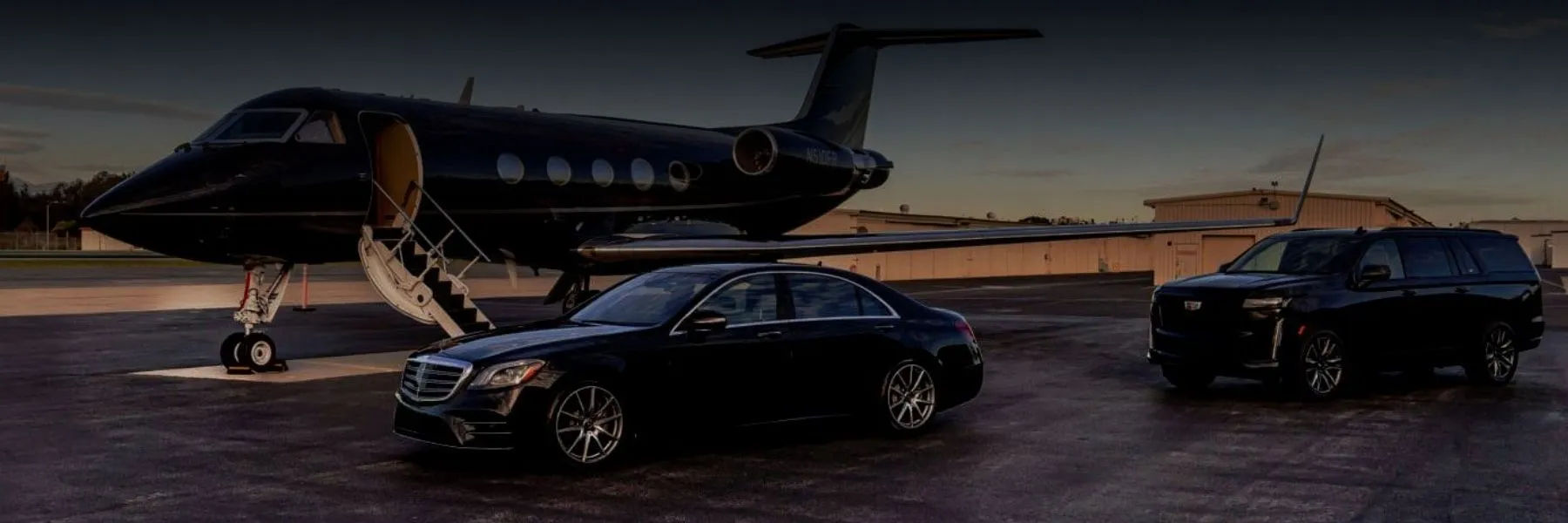 private-jet-fbo-airport-transfer-sedan-suv Black Mercedes sedan and Cadillac Escalade SUV parked on airport tarmac next to a private jet for VIP FBO transfers